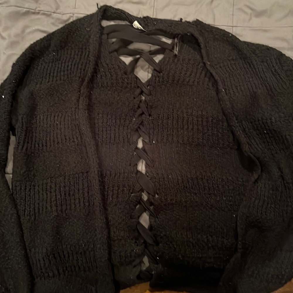 Black cardigan with lace detailing along the back